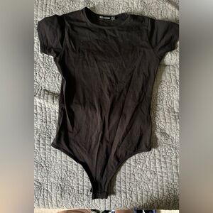 Two pretty little thing body suits - black size 6